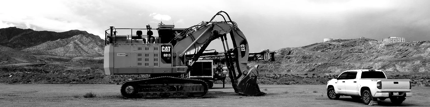 CAT 6015 mining excavator on a desert site, monochrome