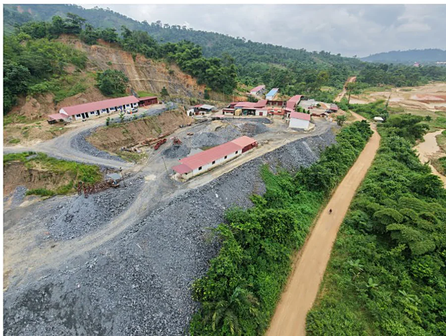 Aerial view of a mining camp in green hills