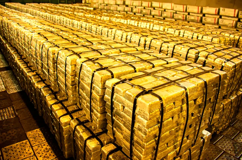 Strapped and sealed gold bar pallets in vault storage